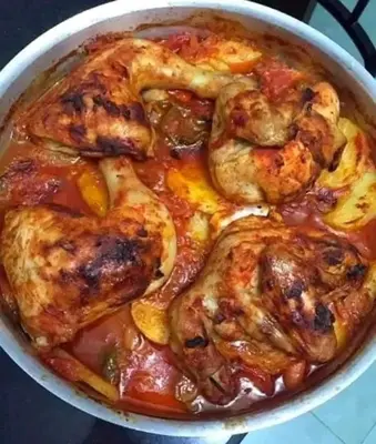 a pot of food with shrimp in a sauce at Rawabi INN in Maţār al Malik Ḩusayn