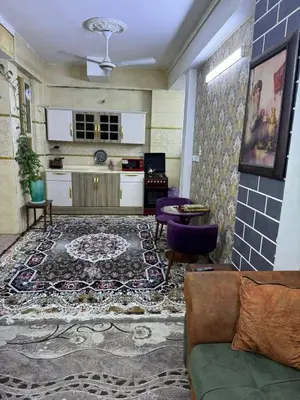 a living room with a couch and a rug at Rawabi INN in Maţār al Malik Ḩusayn