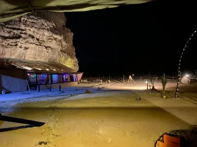 a ski lodge in the snow at night at Rose Al Ghaith Camp in Disah