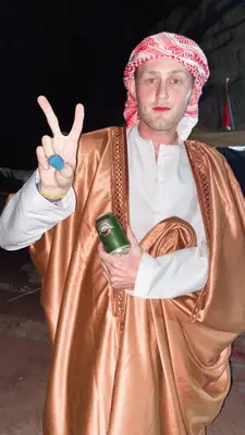 a man in a costume giving a peace sign at The heartbeat of the desert and the stars in Wadi Rum