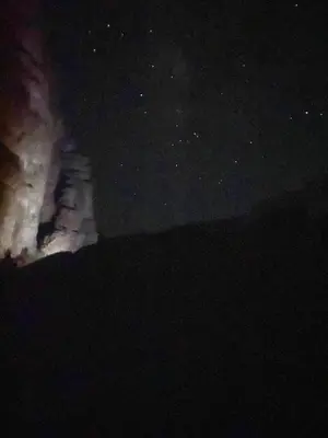 a night sky with stars and a group of buildings at The heartbeat of the desert and the stars in Wadi Rum