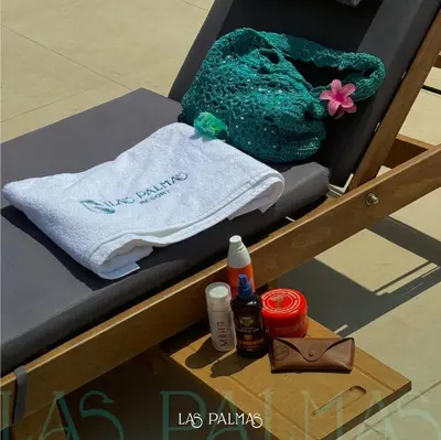 a bed with a towel and a purse on a table at Las palmas resort in Sowayma