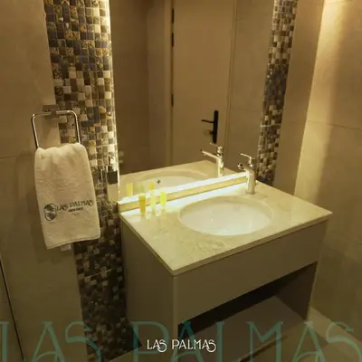 a bathroom with a sink and a mirror at Las palmas resort in Sowayma