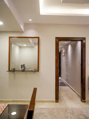 a mirror on the wall next to a hallway at Yafa 2BR N Abdoun Apartment in Amman