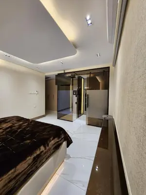 a bedroom with a bed in the middle of a room at Halimah 3BR Luxury Apt-Der Ghbar in Amman