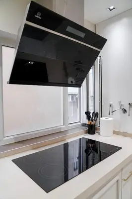 a kitchen with a black stove top oven at Halimah 3BR Luxury Apt-Der Ghbar in Amman