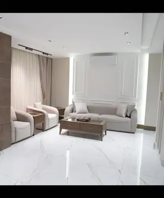 a living room with two couches and a coffee table at Halimah 3BR Luxury Apt-Der Ghbar in Amman