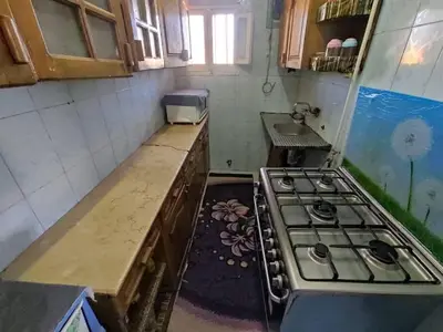 a kitchen with a stove top oven in a room at Zarmot INN in Az Zarqa