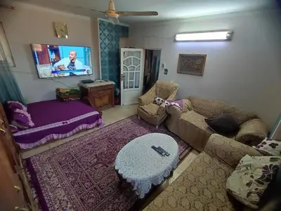a living room with a couch and a bed at Zarmot INN in Az Zarqa