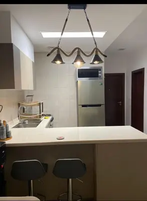 a kitchen with two bar stools and a counter top at Al RAHA village - Aqaba أستوديو بقرية الراحه العقبة مرسى زايد in Aqaba