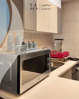 a microwave oven on a counter in a kitchen at Al RAHA village - Aqaba أستوديو بقرية الراحه العقبة مرسى زايد in Aqaba