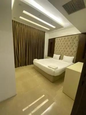 a hotel room with a bed and a table at abdoun rooftop 1bedroom kh&sh 04 in Amman