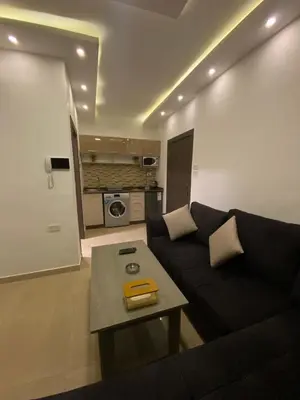 a living room with a couch and a table at abdoun rooftop 1bedroom kh&sh 04 in Amman