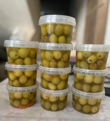 a group of plastic containers filled with green lemons at Nassen House in Udhruḩ