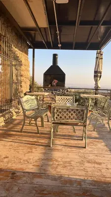 a patio with benches and a grill with a stove at Olive house in Um Qeis