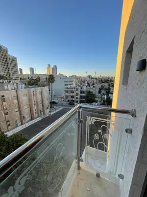 a balcony with a view of a city at Sawa Apartment in Amman