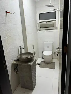 a bathroom with a sink and a toilet at Poster apartment in Maḩaţţat Jurf ad Darāwīsh