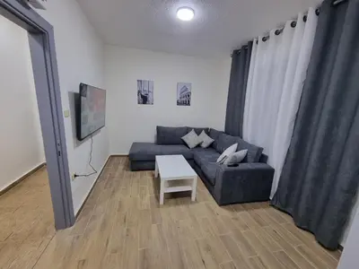 a living room with a couch and a table at Sama Dier Ghbar 3 in Amman