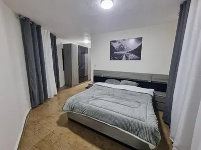 a bedroom with a bed in a room with windows at Sama Dier Ghbar 3 in Amman