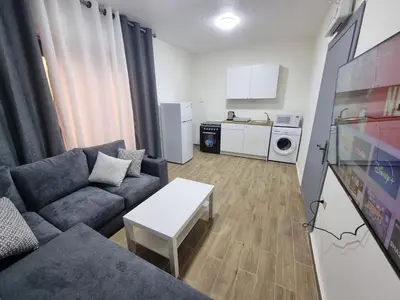 a living room with a couch and a table at Sama Dier Ghbar 3 in Amman