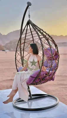 a doll is sitting in a swing at RUM CITY STAR BUBBLE lUXURY CAMP in Wadi Rum