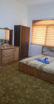 a bedroom with a bed with a blue ribbon on it at zragat hotel in Jerash