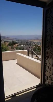 a view from the window of a balcony at zragat hotel in Jerash