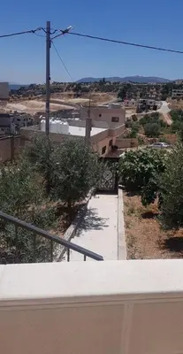 a view of a walkway in a city with buildings at zragat hotel in Jerash