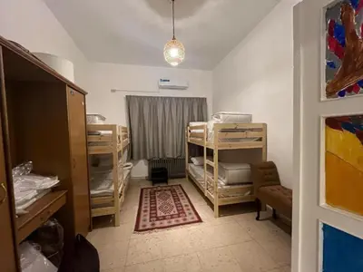 a room with a room with bunk beds in it at Lukanda Apartment Feel at Home in Amman