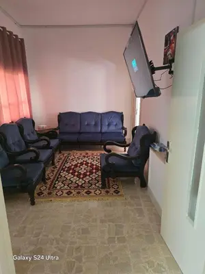 a living room with couches and a flat screen tv at Lukanda Apartment Feel at Home in Amman