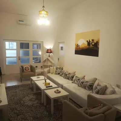a living room with a couch and a table at Lukanda Apartment Feel at Home in Amman