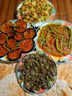 a group of plates of food on a table at carfort House in Al Jafr
