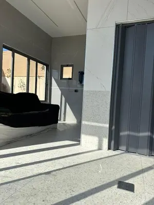 a living room with a couch and a large glass door at the royal occasion amman in Amman