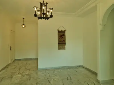 a room with a wall with a clock on the wall at Layal's apartment in Amman