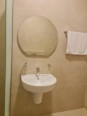 a bathroom with a sink and a mirror on the wall at Layal's apartment in Amman
