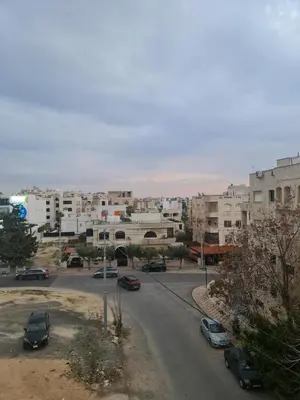 a view of a city with cars parked on a street at Layal's apartment in Amman