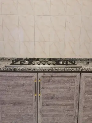 a stove top oven sitting on top of a counter at Layal's apartment in Amman