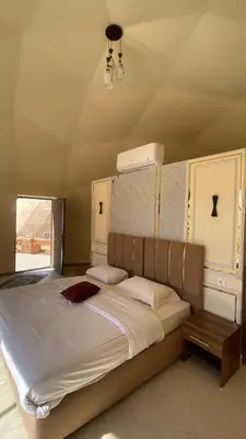 a bedroom with a large bed in a room at Amin Camp in Wadi Rum