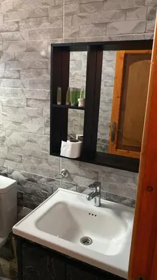 a bathroom with a sink and a mirror at Amin Camp in Wadi Rum