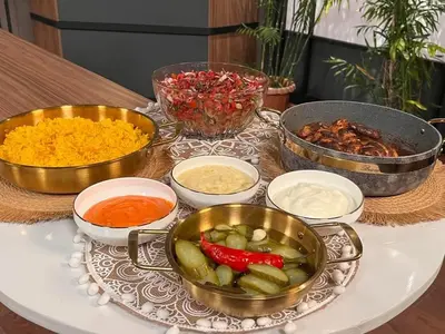 a table topped with bowls of ingrediants and vegetables at jarmy house in Ash Shajarah