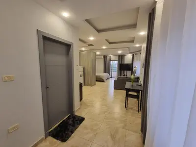 a hallway with a door leading to a living room at Sama Dier Ghbar 5 in Amman