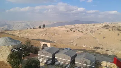 an aerial view of a building in the middle of a desert at Dana local Life Eco lodge in At-Tafilah