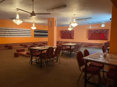 a restaurant with tables and chairs in a room at Baytna Hotel in Petra