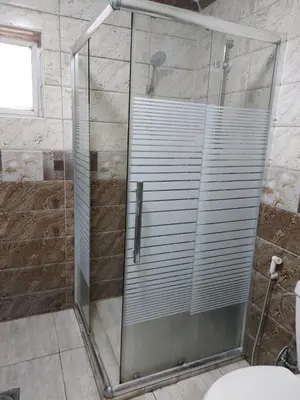 a shower with a glass door in a bathroom at Casa la Serena in Madaba