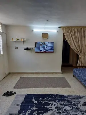 a living room with a flat screen tv on a wall at Casa la Serena in Madaba