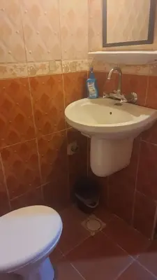 a bathroom with a white sink and a toilet at الدونق in Amman