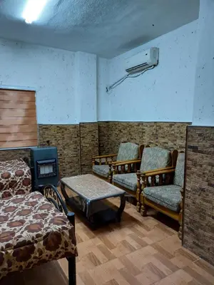 a room with two beds and a fire place at الدونق in Amman