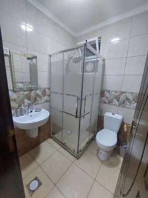 a bathroom with a shower and a toilet and a sink at New zarqa20 km from Amman in Az Zarqa