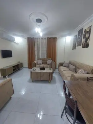 a large living room with couches and a table at New zarqa20 km from Amman in Az Zarqa