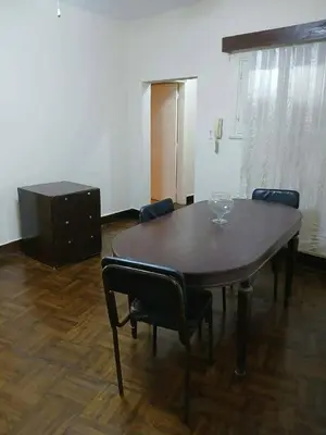 a dining room table with chairs and a dresser at دبه حانوت هاوس in Raʼs an Naqb